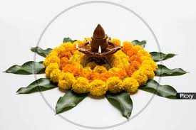 image of flower rangoli with diya for