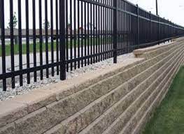 building a fence on top of retaining walls