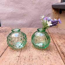 pair of round green glass bud vases