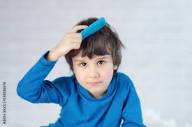 years old combing his hair stock photo