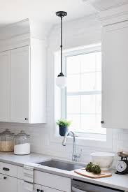 Small White Glass And Bronze Vintage Light Over Kitchen Sink Transitional Kitchen