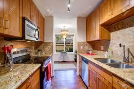 What an incredible difference!, i agree with sharon about the maple cabinets being okay with new/light counters,backsplash, appliances and flooring, but really; Small Galley Kitchen Design With Black Kitchen Appliances Maple Stock Photo Picture And Royalty Free Image Image 96303322