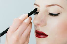 makeup artist applying eyeshadow to