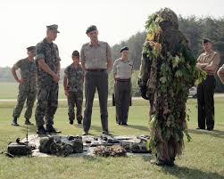 a marine sniper wearing a ghillie suit
