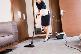 housemaid cleaning carpet