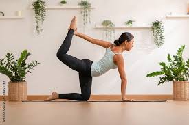 focused asian woman practicing yoga