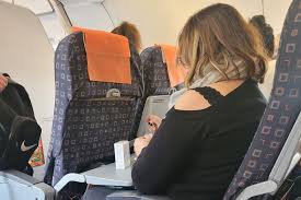 woman painting her nails on flight