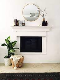 round mirror over fireplace