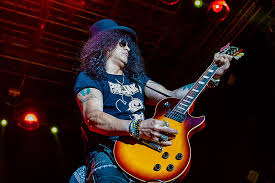 Saul hudson, better known by his stage name slash, is the current lead guitarist of hard rock band guns n' roses. Slash Confirms New Guns N Roses Music Is Absolutely Happening
