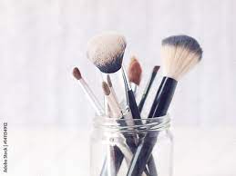 set of makeup brushes in a gl jar on