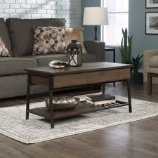 Shelved storage visible through cabinet doors with inset metal grills. Wystfield Coffee Table Wayfair