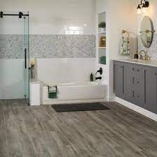 Vinyl flooring works extremely well in bathrooms, as it's waterproof, durable, and incredibly versatile—it can mimic hardwood and ceramic. Lifeproof Shadow Wood 6 In X 24 In Porcelain Floor And Wall Tile 14 55 Sq Ft Case Lp33624hd1pr The Home Depot