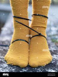 Closeup of tied female legs in thick socks Stock Photo - Alamy