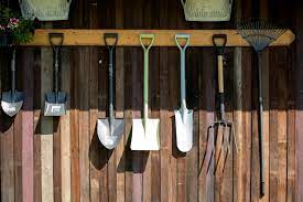 Gardening Tools Hang On Wooden Wall