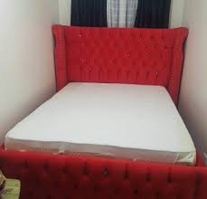 Red Chesterfield On Tufted Bed