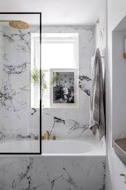 A beige bathroom fully clad with marble, with an oval tub, large mirrors and a window for more light. Upgrade Your Bathroom With These Stunning Chic Marble Bathroom Designs Marble Bathroom Marble Bathroom Designs White Marble Bathrooms