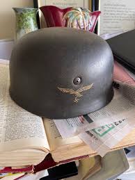 Helmet that my boss owns. Just want to know if it's real? Googled Nazi  helmets and nothing looking like this came up and saw a post here a few  months back suggesting