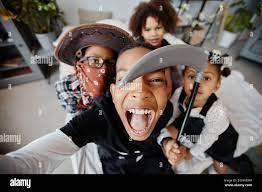 POV shot of excited African-American kids taking selfie on Halloween while  wearing costumes Stock Photo - Alamy