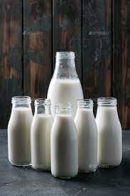 fresh milk in diffe glass bottles