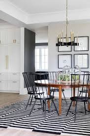 The ideal piece to add drama to your dining area. Oval Dining Table On Black And White Stripe Rug Transitional Dining Room