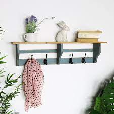 rustic wooden wall shelf with coat hooks