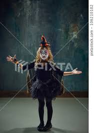child with colorful witch makeup