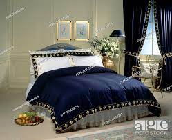 bed with white pillows and gold trimmed