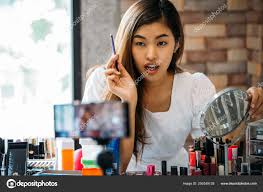 pretty asian woman recording makeup