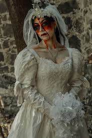 a woman dressed as a zombie bride with