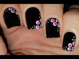 black nails with pink flower nail art