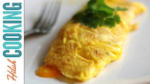 Tilt the pan, and with a spatula, lift up the omelet at the edge, allowing the raw egg to run underneath. How To Make An Omelet Easy Cheesy Omelet Recipe Video Youtube