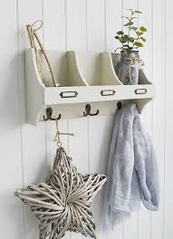 white wooden wall shelf with hooks