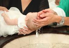 Who holds the baby during baptism?