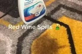 woman cleans red wine stain on carpet