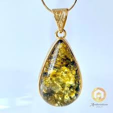 green amber pendant with inclusions