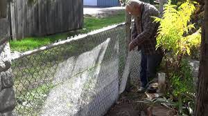 chain link fence to a stone wall