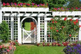 White Garden Gate With Flowers Stock