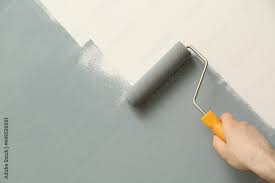 Man Applying Grey Paint With Roller