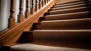 carpeted stairs to a wood floor