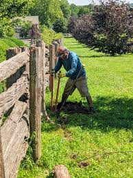 replacing fence posts at the farm the