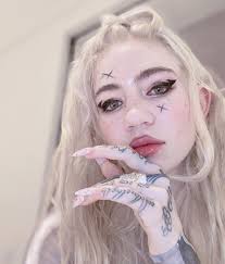 Extreme body modifications have taken on many forms in recent years. Grimes Unveils Gnarly Full Back Tattoo