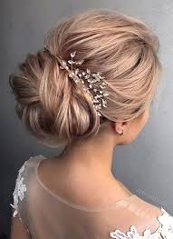 Simple wedding updo hairstyle worn with a center parting that has got loose curls hanging on sides of the face to create a pretty look. Gorgeous Wedding Updo Hairstyle To Inspire You