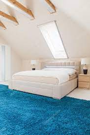 bedroom with blue carpet stock photo by