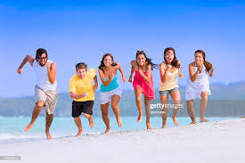 Group Of Young People Running And Competing On A Beach High-Res Stock Photo  - Getty Images