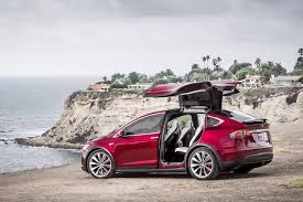 The raised roof and relatively low floor the front door bins are big enough to hold a large bottle, there are a few clever adjustable cupholders in the centre console and another storage tray in. Tesla Model X Electric Meets Extravagant Wsj