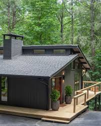 black farmhouse in the woods home
