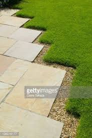 I've run into this problem a few times shopping at lowe's. Paving With Uneven Lawn Edging The Lowes Garden The Coach House Haslemere Su Modern Design Lawn Edging Backyard Landscaping Lawn Care