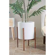 Whether you want to liven up the living room or create a lush urban garden on your patio, terrace or deck, the right planters and flower pots will ensure your plants make a big impact when it comes to style. Mid Century Modern White Ceramic Planter With Wood Stand