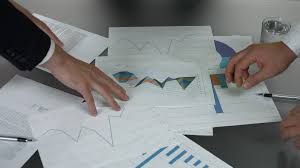 Hands And Business Documents Papers With Charts Professionals Solving A Difficult Task