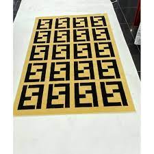 fendi carpets are golden and black فندي